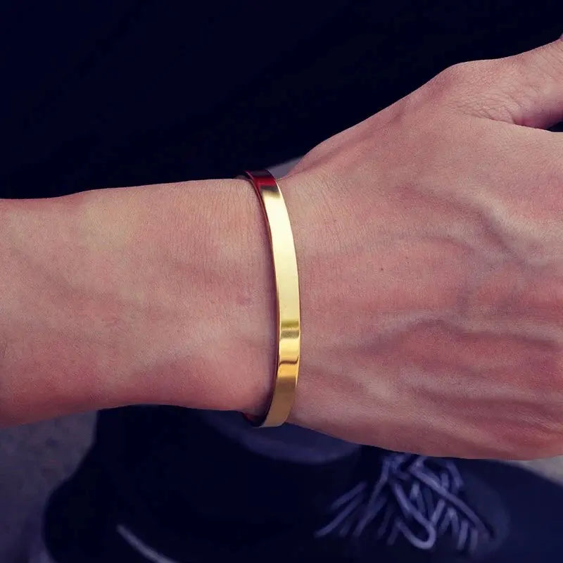 Gold stainless steel open cuff bangle worn on wrist