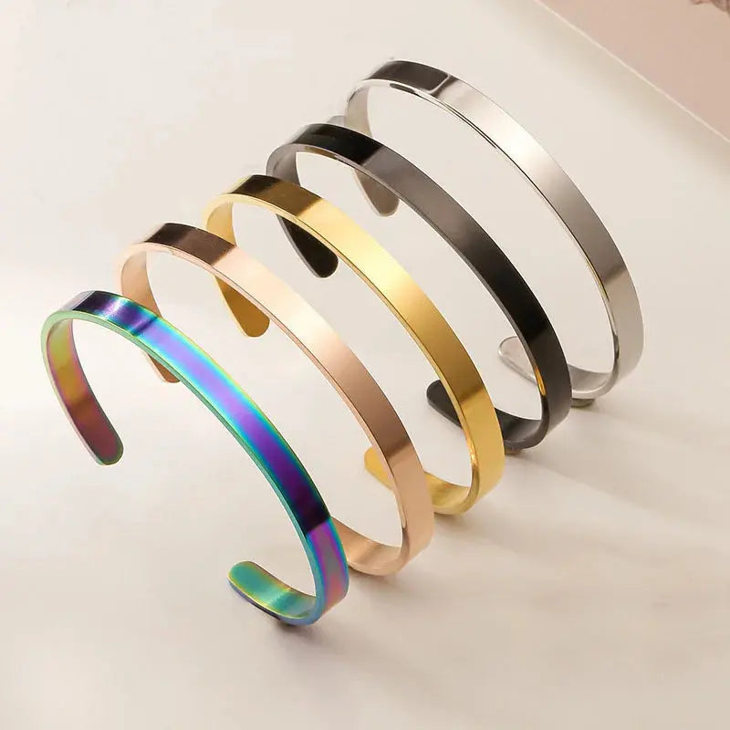Stainless steel open cuff bangles in gold, black, and silver