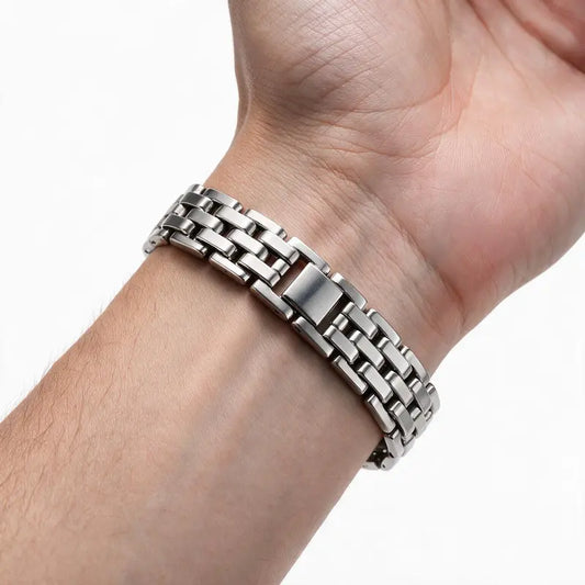 Silver stainless steel watch-link bracelet worn on wrist, white background