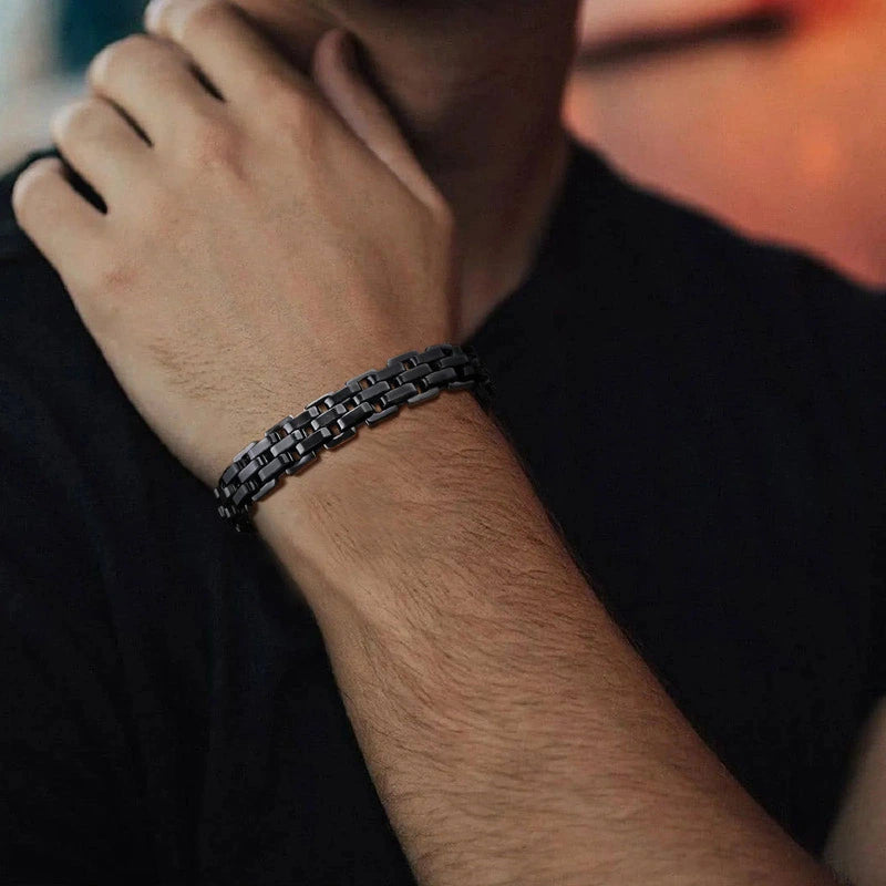 Black stainless steel watch-link bracelet worn on wrist