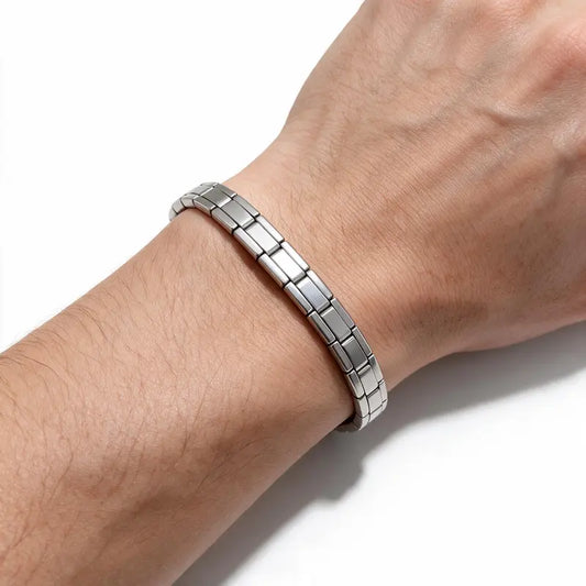 Silver stainless steel Italian link bracelet worn on wrist, white background