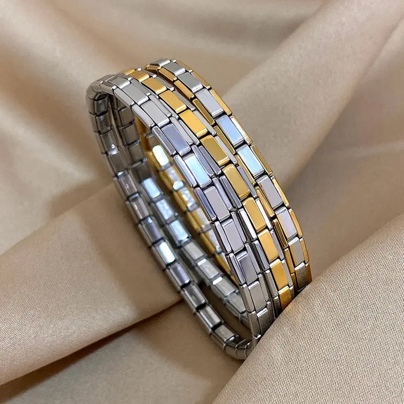 Stainless steel Italian link elastic bracelets in silver, gold, and two-tone finishes