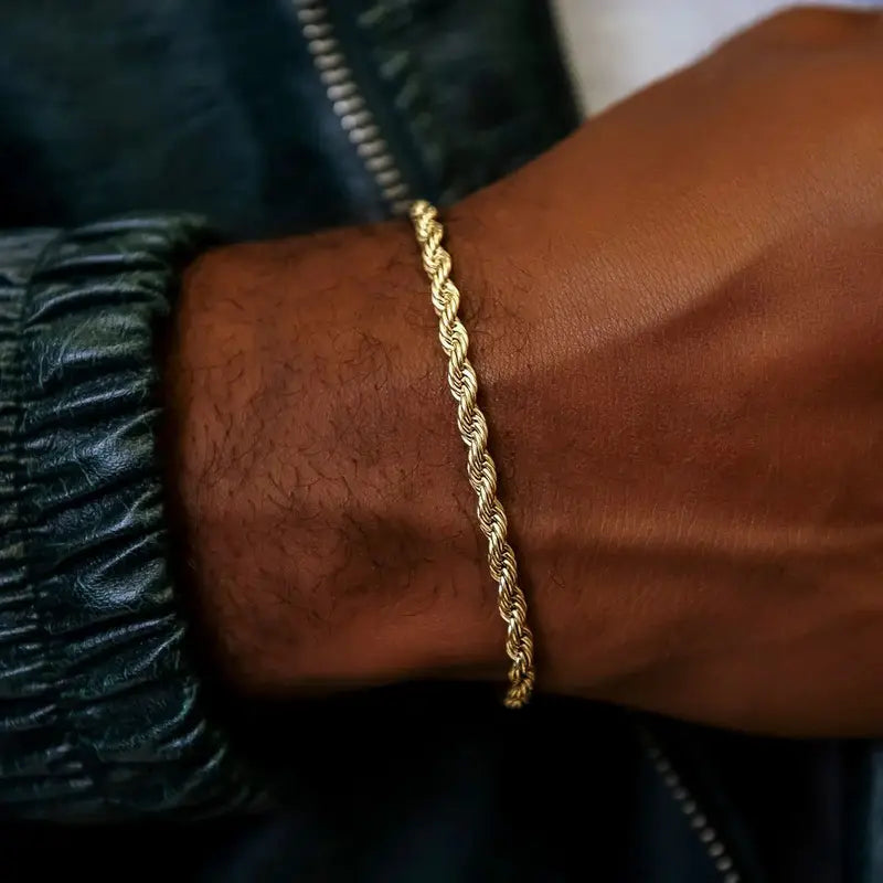 Close-up of gold twisted rope chain bracelet on wrist