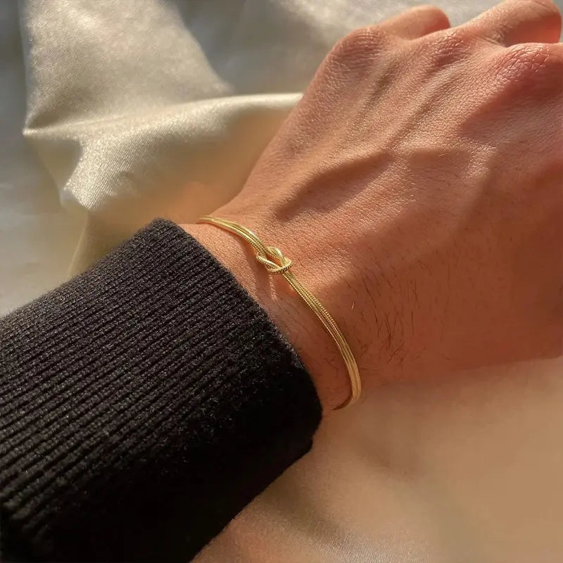 Gold stainless steel knot chain bracelet worn on wrist