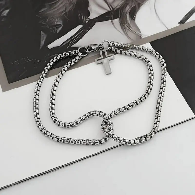 Stainless steel double box chain bracelet with cross charm flat lay