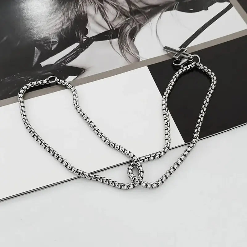 Double strand stainless steel bracelet with hollow cross charm flat lay