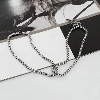 Double strand stainless steel bracelet with hollow cross charm flat lay