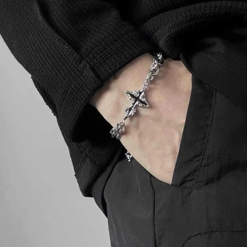 Dark stainless steel cross bracelet worn on wrist