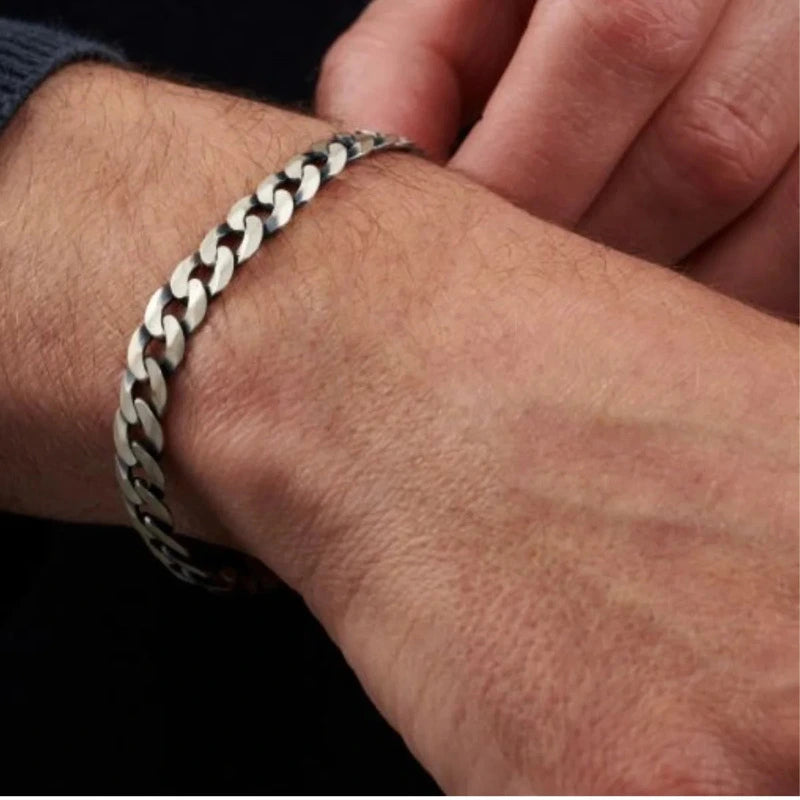 Close-up of silver stainless steel curb chain bracelet clasp