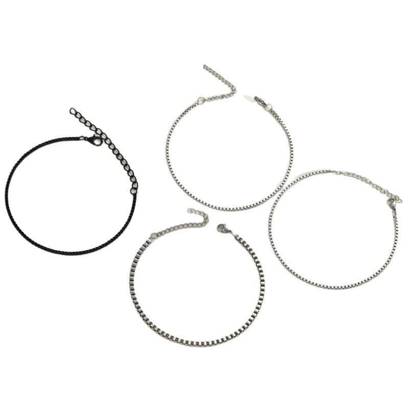 4-piece stainless steel box chain bracelet set on orange background