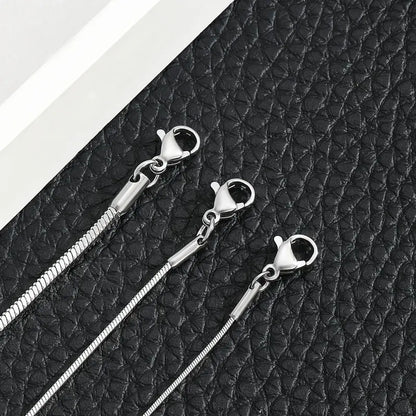 Close-up of silver snake chain bracelet lobster clasps