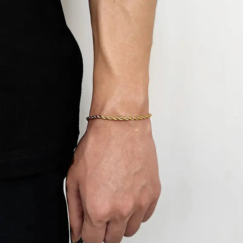 Gold twisted rope chain bracelet worn on wrist